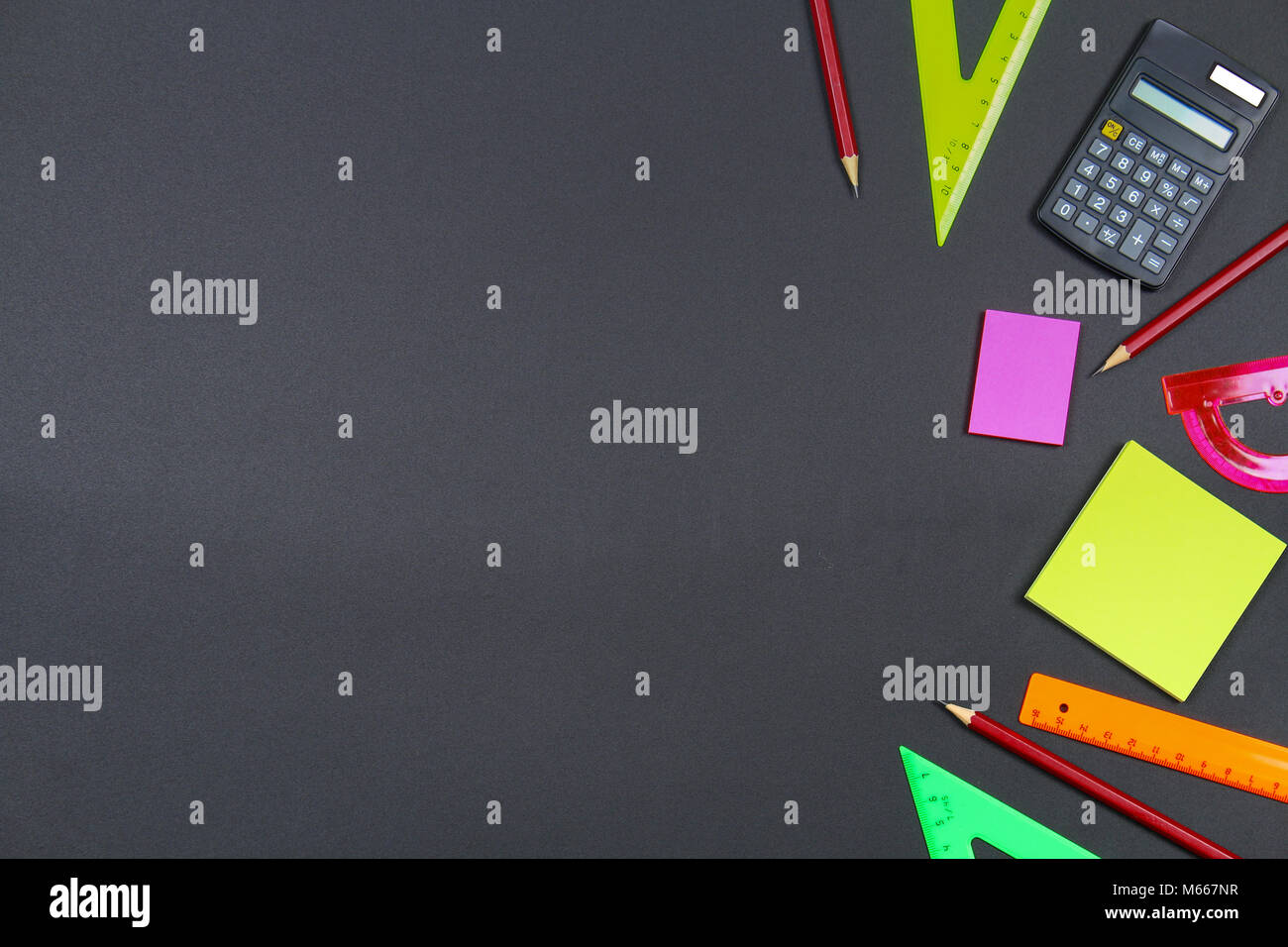 School and office supplies on blackboard background. Top view with copy ...