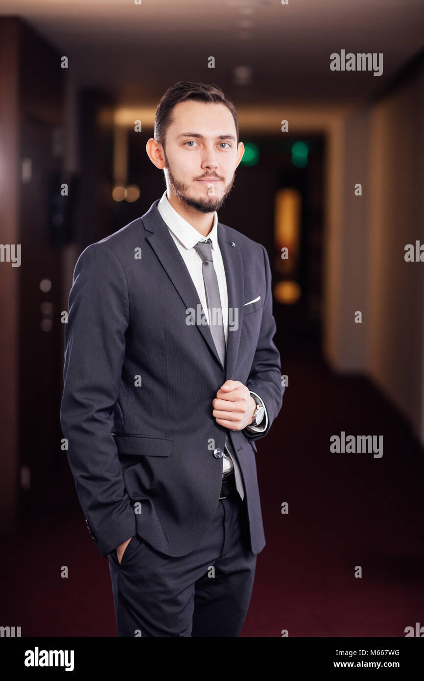 happy businessman with arms crossed standing in office Stock Photo - Alamy