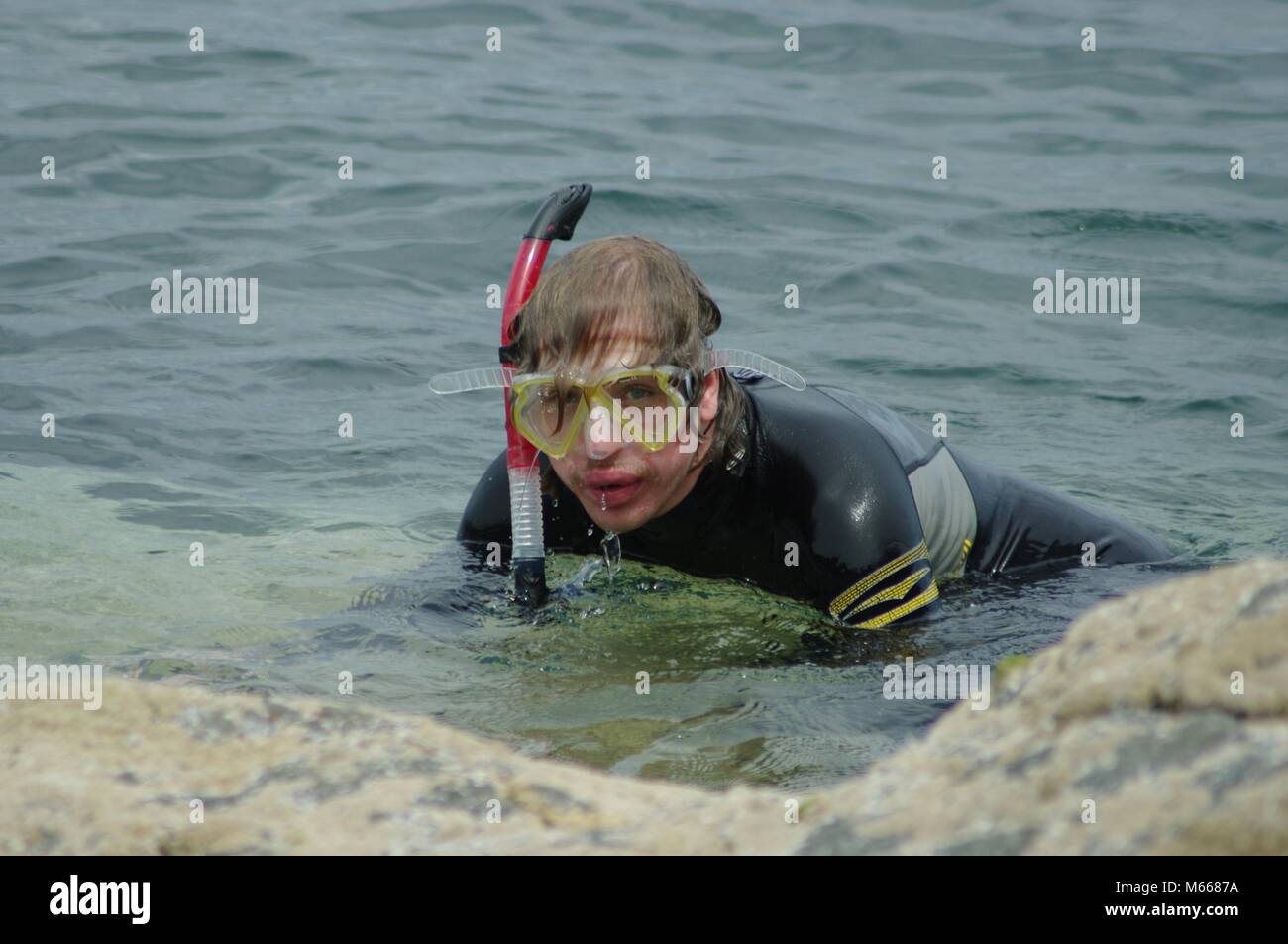 Young Male Snorkeller in Wetsuit Exploring the Submarine World of Beach,