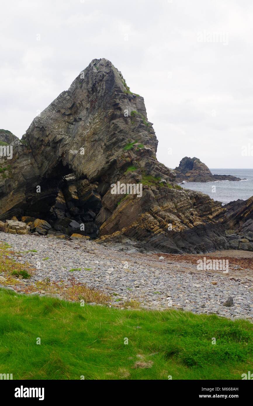 The Needle's Eye, Natural Rock Arch Hole Formation. Macduff, Aberdeenshire, NE Scotland, UK. On a University Geology Field Trip. Stock Photo