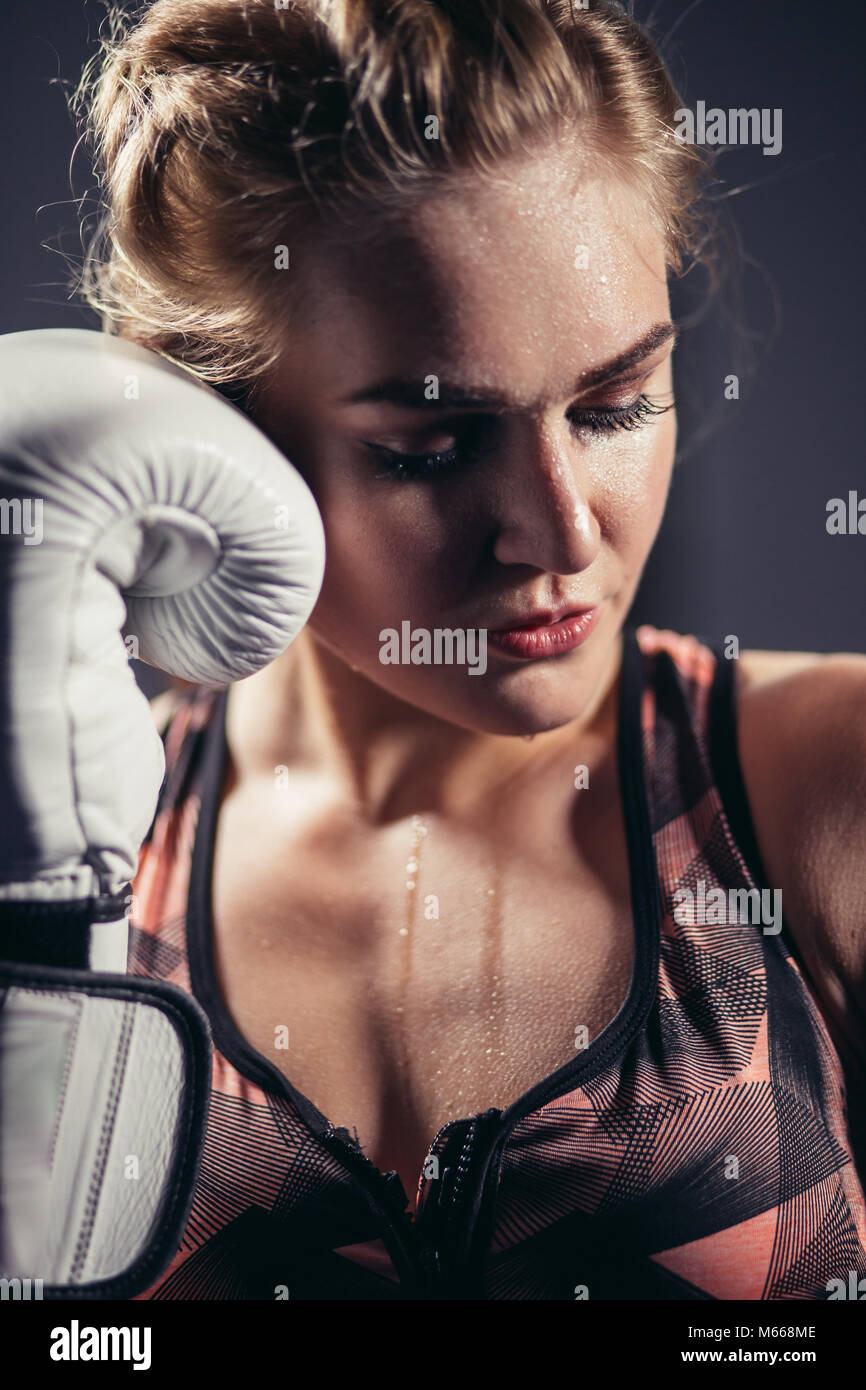 Female Boxer wearing gloves posing in boxing studio Stock Photo Alamy