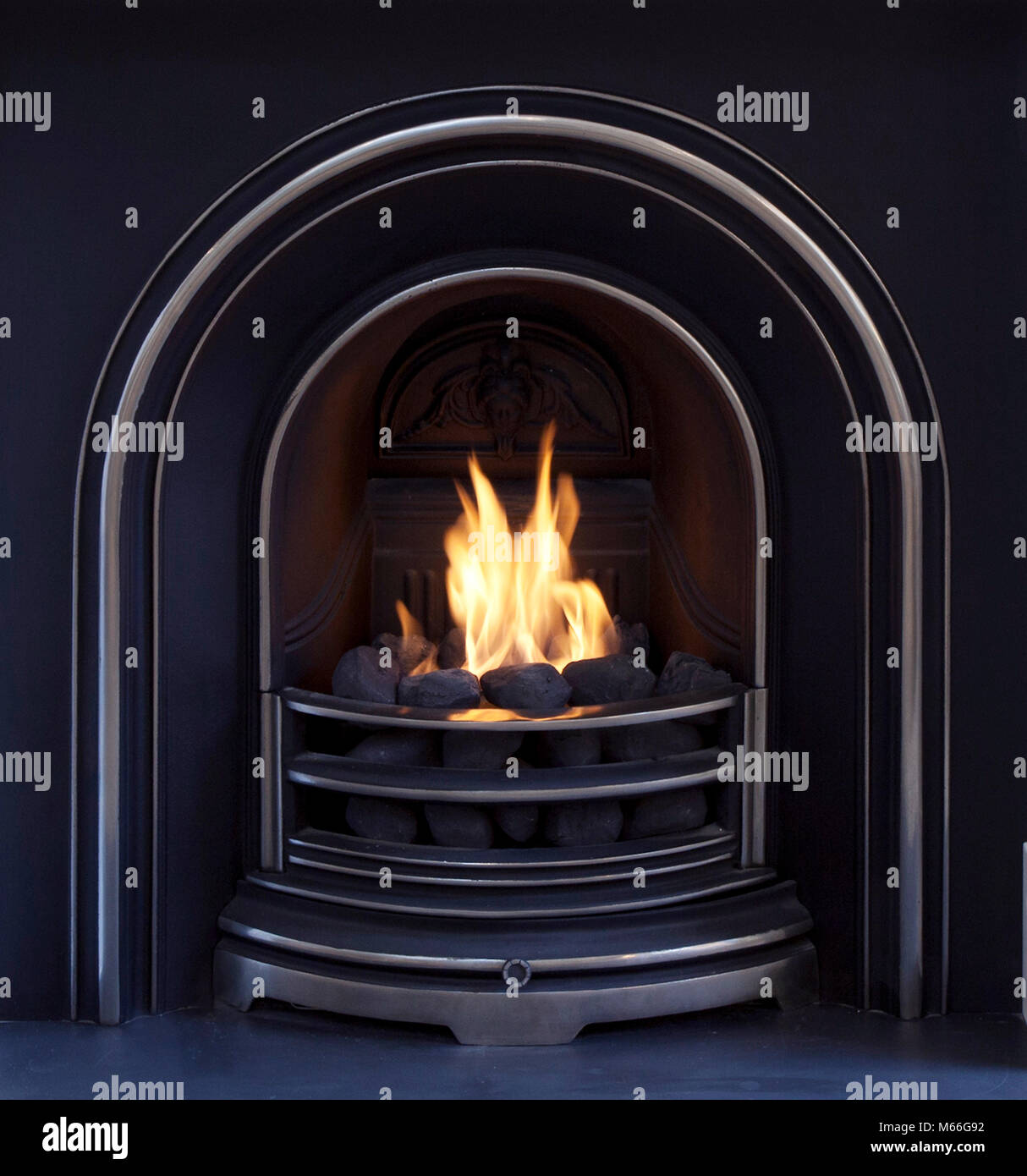 open coal effect gas fire with metal fire place with flames Stock Photo