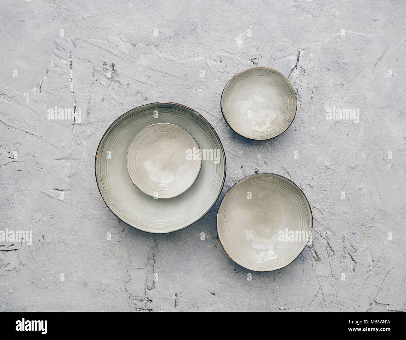 Ceramic bowls on a textured background Stock Photo - Alamy