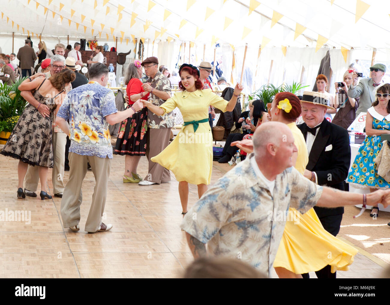 1950's dance at the Goodwood revival with vintage clothes brightly coloured shirts and dresses Stock Photo