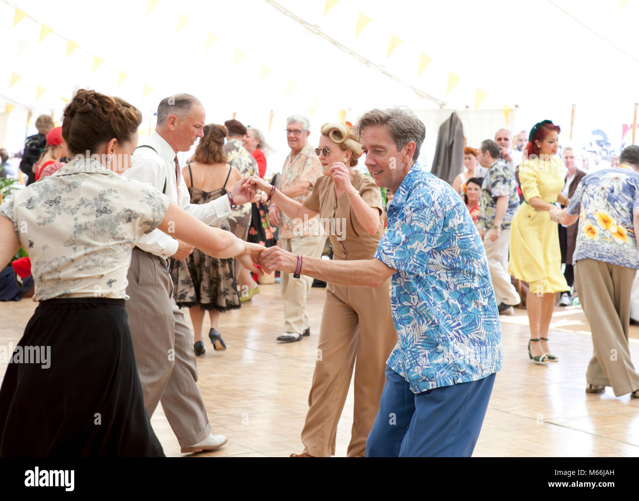1950's dance at the Goodwood revival with vintage clothes brightly coloured shirts and dresses Stock Photo