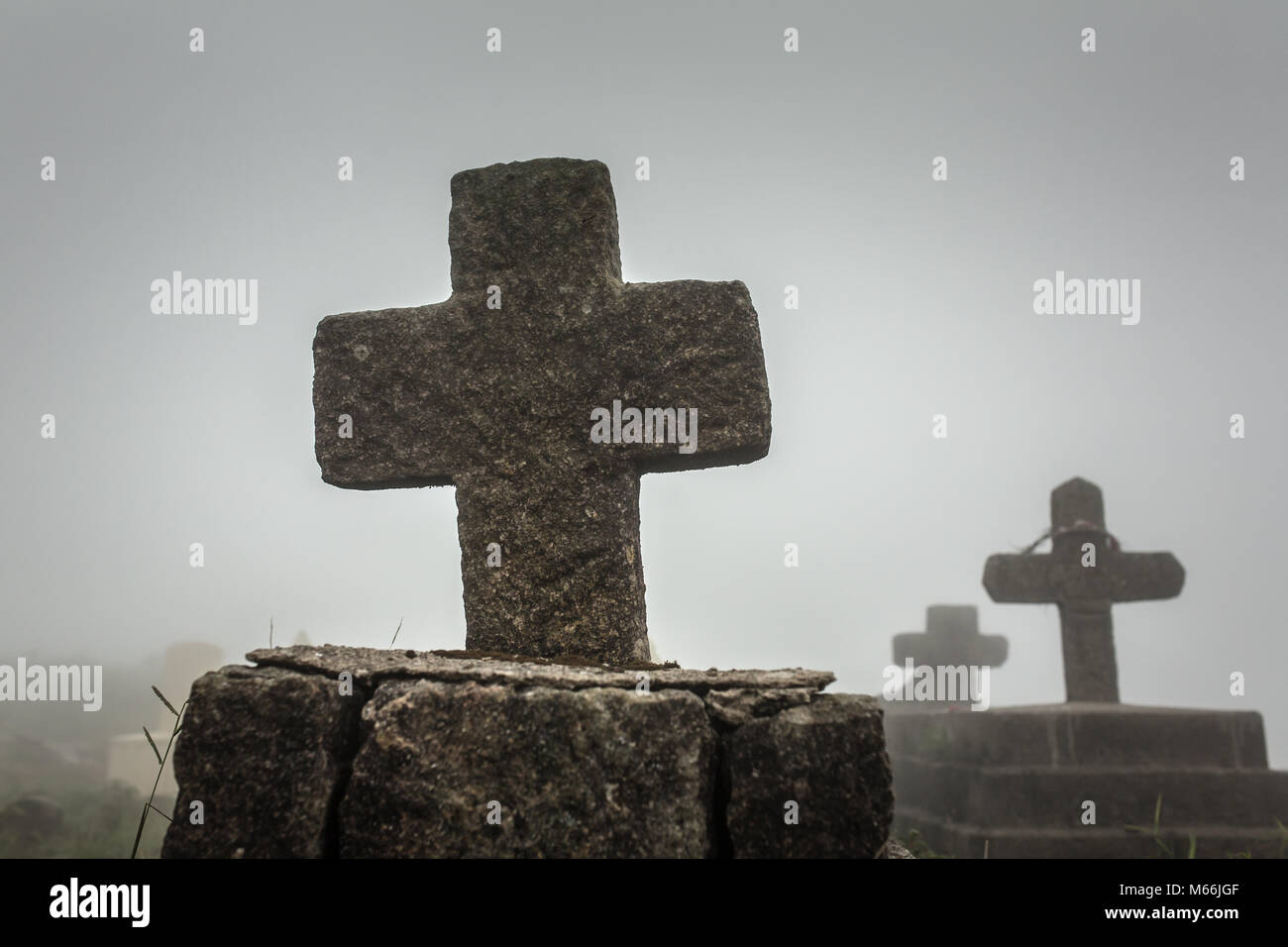 Old christian cemetery in Meghalaya, Northeast India. Silhouette of cross on cloudy day. Stock Photo