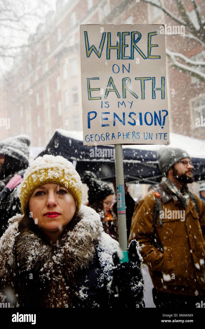 University staff and students demonstrated in Central London .A geography teacher holds a placard saying 'Where on earth is my pension'. Stock Photo