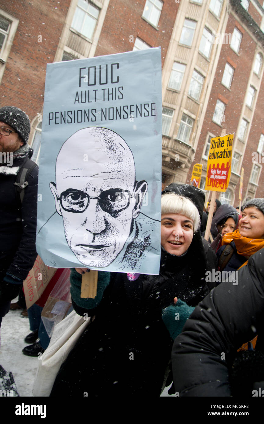 University staff and students demonstrated in Central London. A member of the Anthropology department holds a poster referencing Foucault Stock Photo
