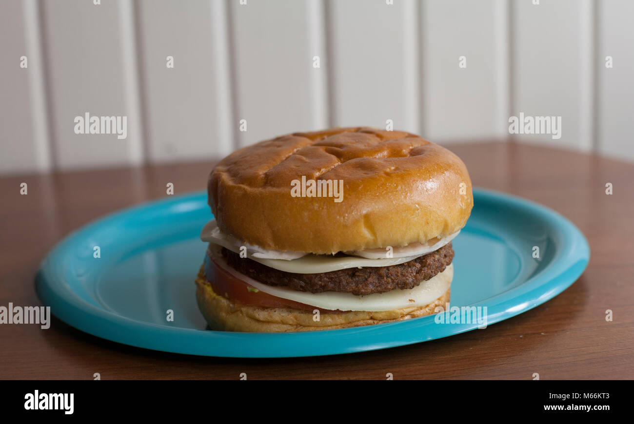 Single veggie burger with provolone cheese on a sweet bun Stock Photo