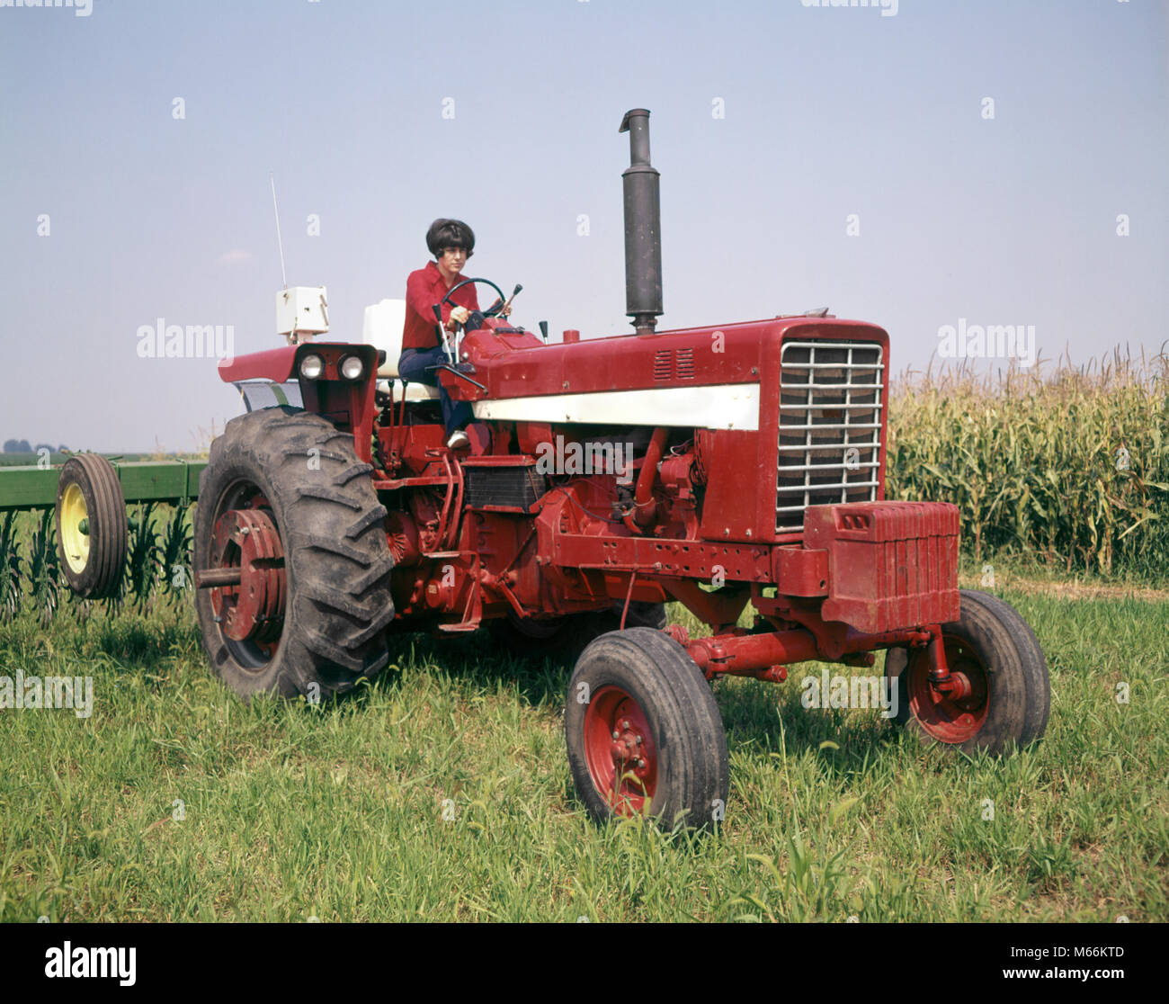 Woman farmer driving old tractor hires stock photography and images