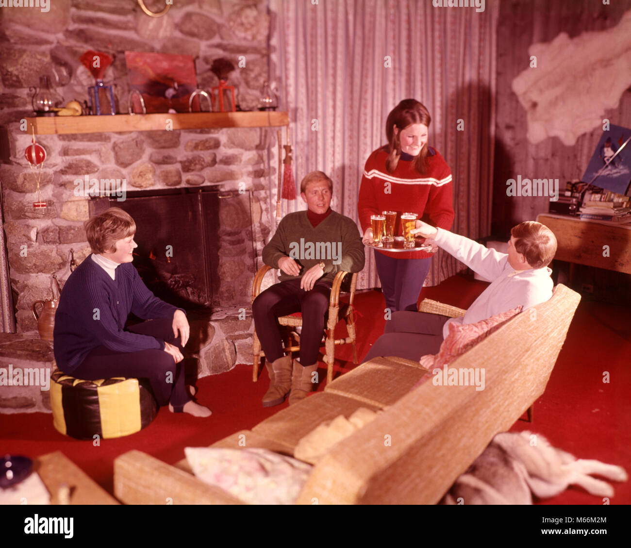 1970s Woman Serving Beer In Ski Lodge By Stone Fireplace Apres Ski