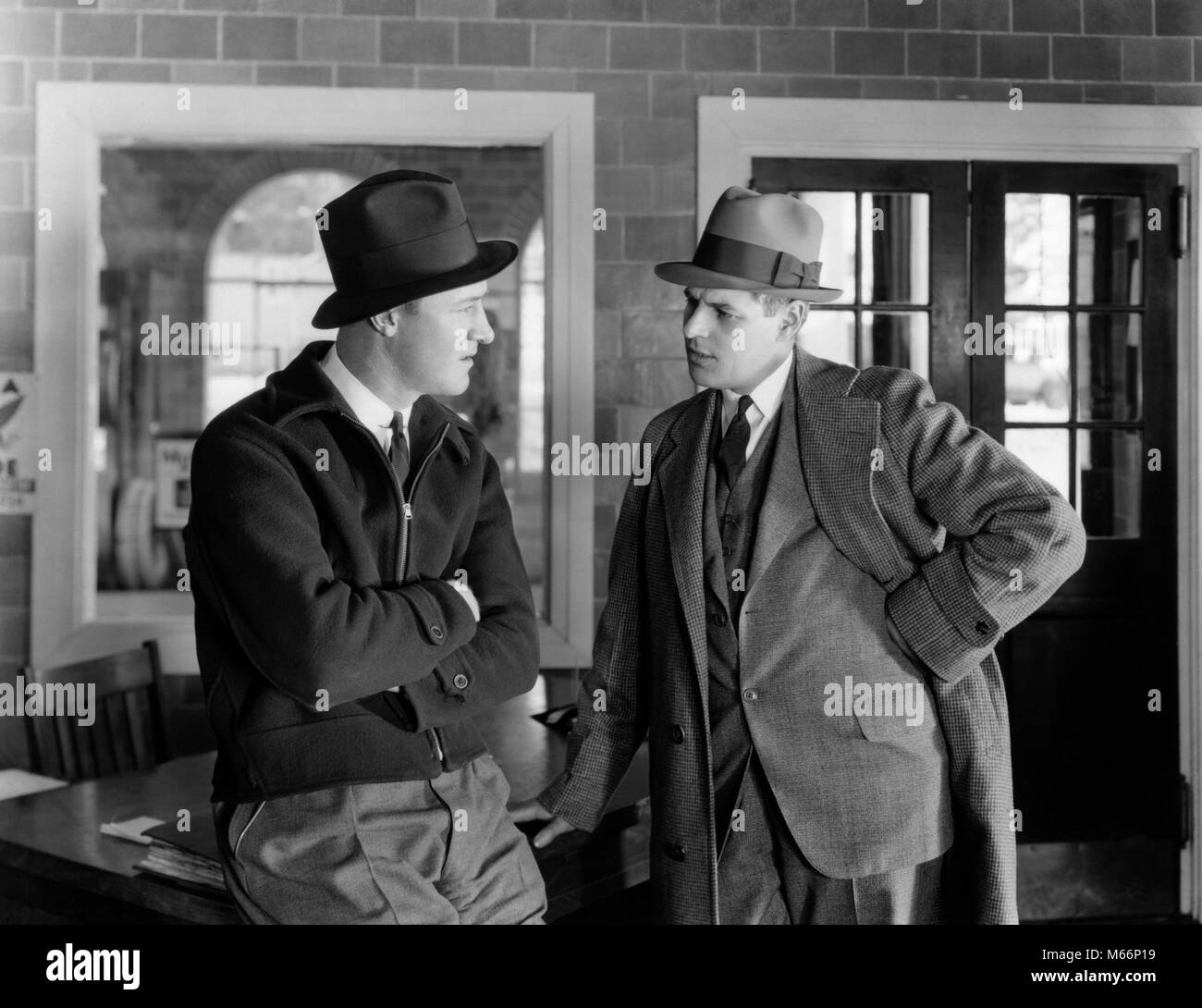 1930s BUSINESSMAN IN SUIT TALKING WITH WORKING MAN EMPLOYEE WEARING JACKET SERIOUS EXPRESSIONS CONVERSATION ON THE JOB - o1810 HAR001 HARS COMMUNICATION TWO PEOPLE CAUCASIAN SATISFACTION JOBS MANAGER COPY SPACE HALF-LENGTH INDOORS EXECUTIVES VEST EXPRESSIONS NOSTALGIA 30-35 YEARS 35-40 YEARS SKILL SUIT AND TIE OCCUPATION SKILLS CUSTOMER SERVICE CONNECTION BOSSES THREE PIECE SUIT SALESMEN EMPLOYEE EMPLOYEES MALES MANAGERS MID-ADULT MID-ADULT MAN B&W BLACK AND WHITE CAUCASIAN ETHNICITY CONTRACTOR OCCUPATIONS OLD FASHIONED PERSONS Stock Photo