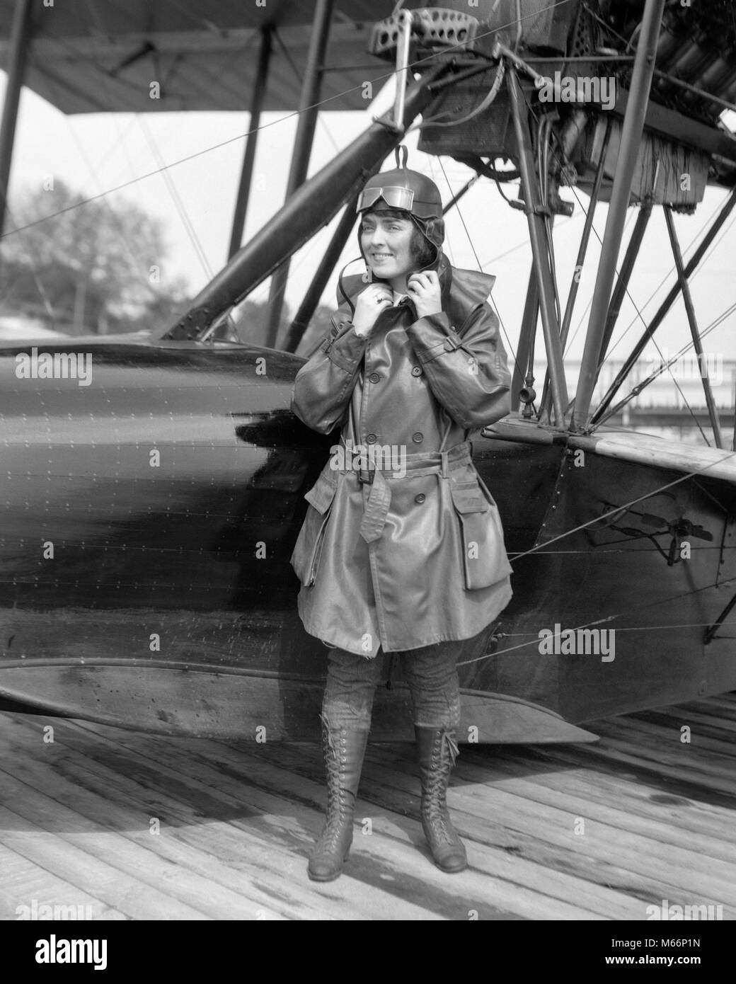 1920s FEMALE AVIATOR AVIATRIX LEATHER COAT CAP WITH GOGGLES AND LACE UP BOOTS PREPARING TO BOARD SEAPLANE - o3255 HAR001 HARS ONE PERSON ONLY PREPARING COPY SPACE FULL-LENGTH LADIES INSPIRATION GOGGLES RISK CONFIDENCE TRANSPORTATION NOSTALGIA 20-25 YEARS 25-30 YEARS FREEDOM PIONEER HAPPINESS CHEERFUL ADVENTURE COURAGE AND EXCITEMENT LEADERSHIP PROGRESS INNOVATION AVIATION SMILES FASHIONS AVIATOR AVIATRIX PIONEERING YOUNG ADULT WOMAN AIRPLANES B&W BLACK AND WHITE BRAVE CAUCASIAN ETHNICITY CIVILIAN COURAGEOUS DARING FEMINIST LACE UP OCCUPATIONS OLD FASHIONED PERSONS SEAPLANE Stock Photo