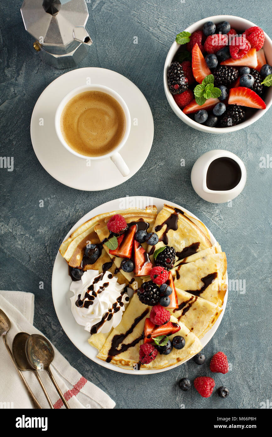 Thin crepes with whipped cream and berries Stock Photo