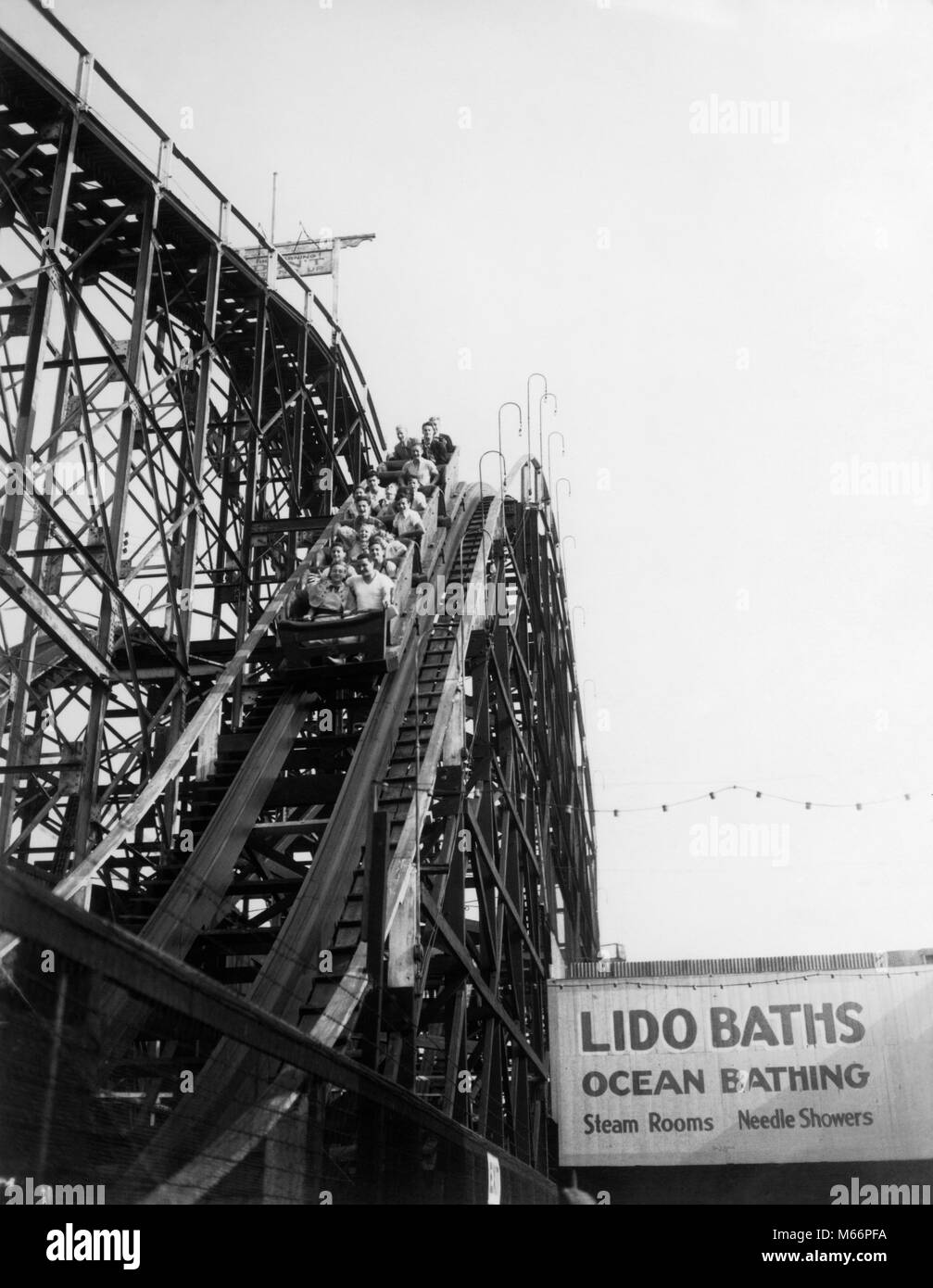 1930s 1940s PEOPLE RIDING CYCLONE ROLLER COASTER CONEY ISLAND BROOKLYN NY USA - r1733 HAR001 HARS SPEED HISTORY CELEBRATION UNITED STATES COPY SPACE UNITED STATES OF AMERICA RISK TEENAGE GIRL TEENAGE BOY ENTERTAINMENT NY AMERICANA NOSTALGIA BROOKLYN HISTORIC AMUSEMENT HEAD AND SHOULDERS ADVENTURE LEISURE RELAXATION EXCITEMENT LOW ANGLE PARKS RECREATION GOTHAM NYC NEW YORK CITIES ESCAPE TEENAGED GROUP OF PEOPLE NEW YORK CITY BOROUGH JUVENILES RIDES YOUNG ADULT MAN YOUNG ADULT WOMAN B&W BLACK AND WHITE CONEY CONEY ISLAND CYCLONE LIDO BATHS NATIONAL REGISTER OF HISTORIC PLACES OLD FASHIONED Stock Photo