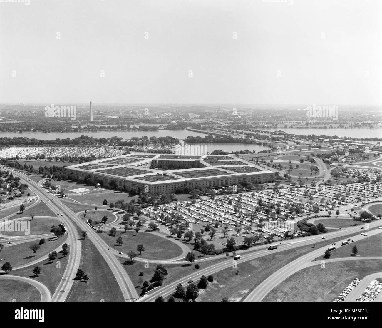 1960s AERIAL VIEW OF THE PENTAGON RIVER CLOVERLEAF TRAFFIC PATTERN ARLINGTON BRIDGE 5 SIDES ARCHITECTURE - r19244 BAU001 HARS WIDE ANGLE CAPITOL PROTECTION STRENGTH VICTORY STRATEGY COURAGE EXTERIOR NOBODY WORLD WARS TRAVEL USA PRIDE WORLD WAR WORLD WAR TWO WORLD WAR II AUTHORITY POLITICS CAPITAL HIGH TECH WORLD WAR 2 HEADQUARTERS POTOMAC SIDES TERRORIST VA 1941 2001 AERIAL VIEW ARLINGTON ARLINGTON COUNTY B&W BLACK AND WHITE CAPITAL CITY CLOVERLEAF DEPARTMENT OF DEFENSE OCCUPATIONS OLD FASHIONED PENTAGON SEPTEMBER 11 SEPTEMBER 11 2001 TERRORIST ATTACK TERRORIST ATTACKS WASHINGTON MONUMENT Stock Photo