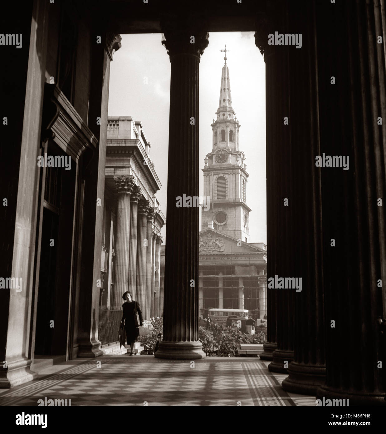 1930s ANONYMOUS SILHOUETTED WOMAN WALKING COLONNADE ST. MARTINS IN THE FIELD CHURCH LONDON ENGLAND - r7521 HAR001 HARS HISTORIC SUCCESS HAPPINESS ADVENTURE SILHOUETTED COLUMN EXCITEMENT KNOWLEDGE RECREATION TOURIST DIRECTION COLUMNS HOLIDAYS TOURISTS TRAVELING ST. VACATIONS VISITING ANONYMOUS TRAVEL EUROPE TRAVELER ARCHITECTURAL DETAIL MID-ADULT MID-ADULT WOMAN RESORTS B&W BLACK AND WHITE CAPITAL CITY COLONNADE FEMALES] MARTINS OLD FASHIONED PERSONS ST. MARTINS IN THE FIELD Stock Photo