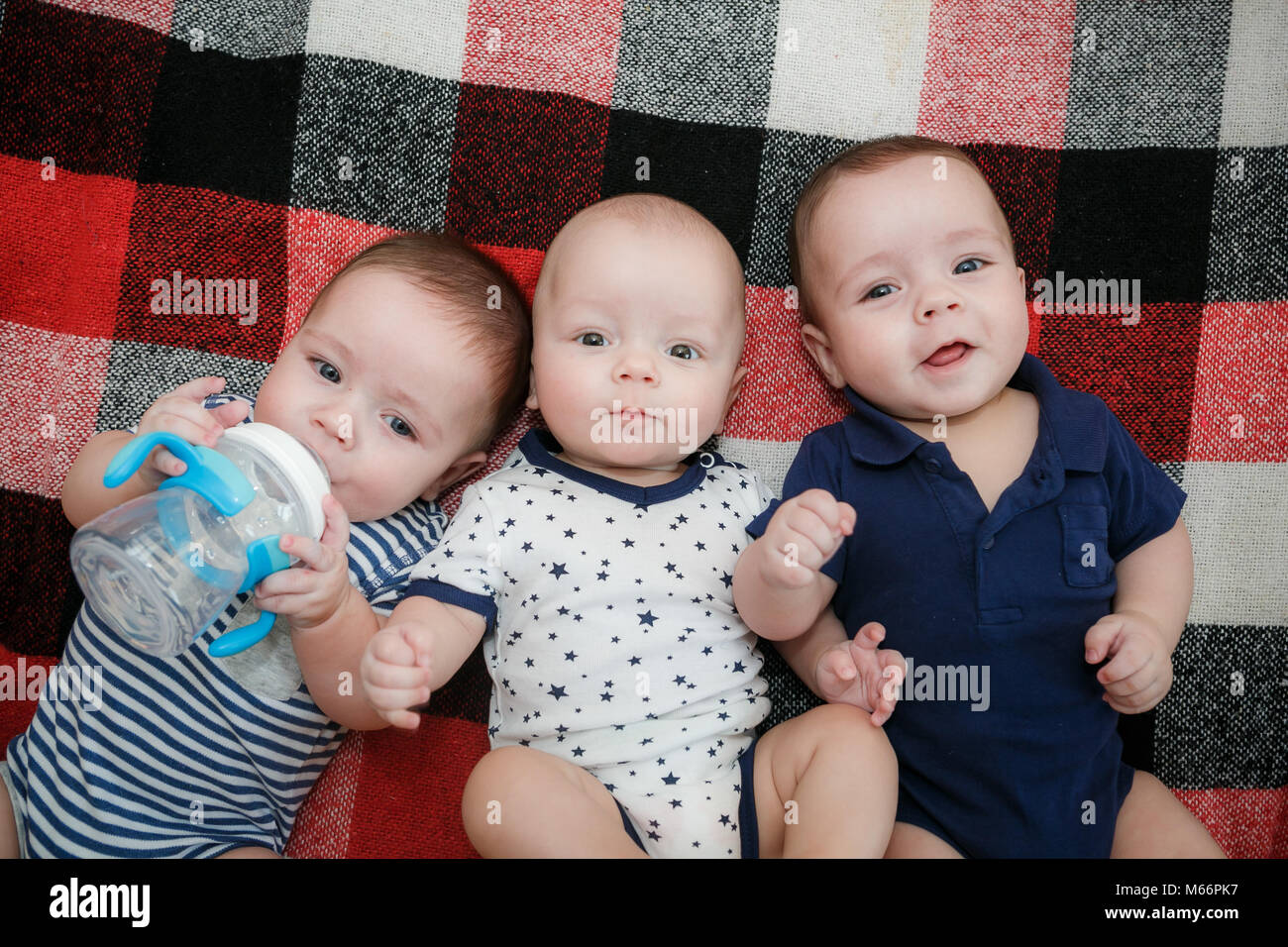 Portrait of newborn triplets are lying in the bed Stock Photo Alamy
