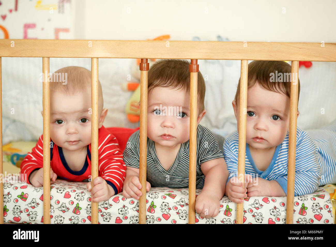 Portrait of newborn triplets in the bed Stock Photo Alamy