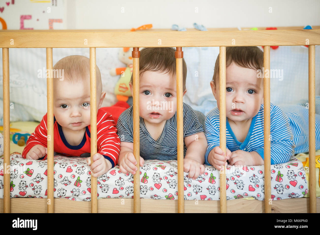 Portrait of newborn triplets in the bed Stock Photo Alamy