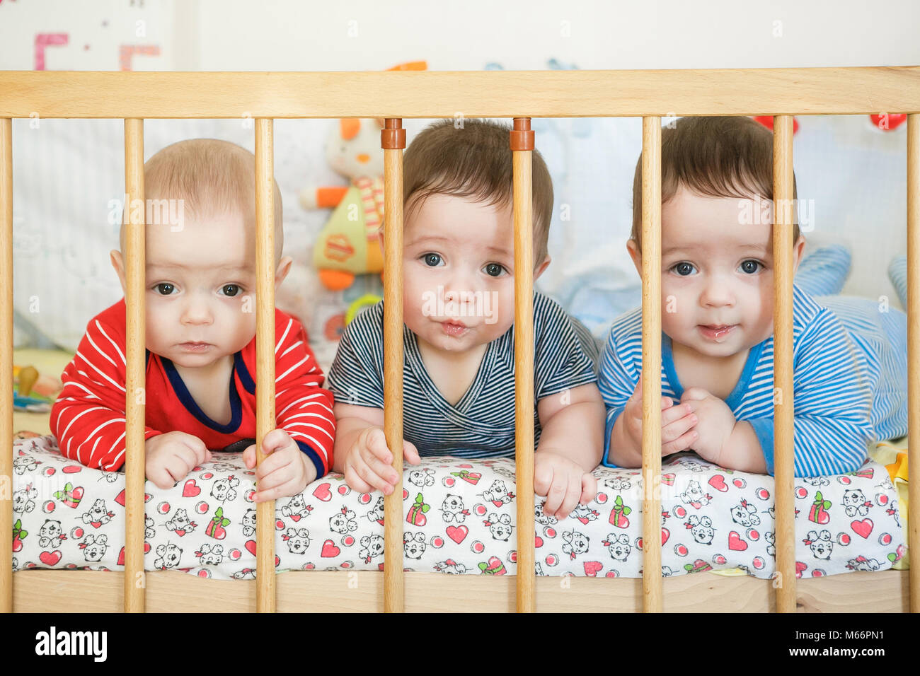 Portrait of newborn triplets in the bed Stock Photo Alamy