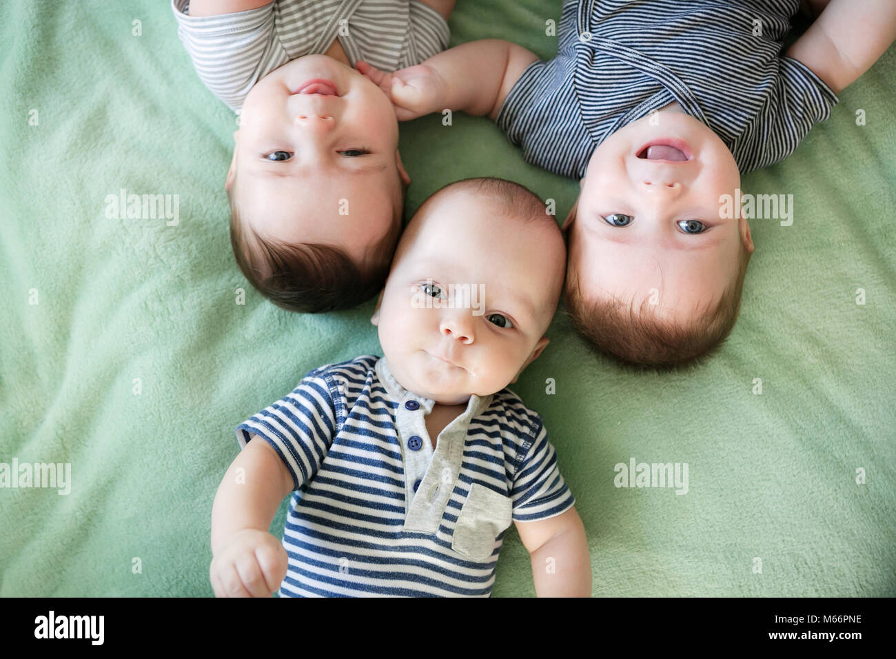 Portrait Of Newborn Triplets Are Lying In The Bed Stock Photo - Alamy