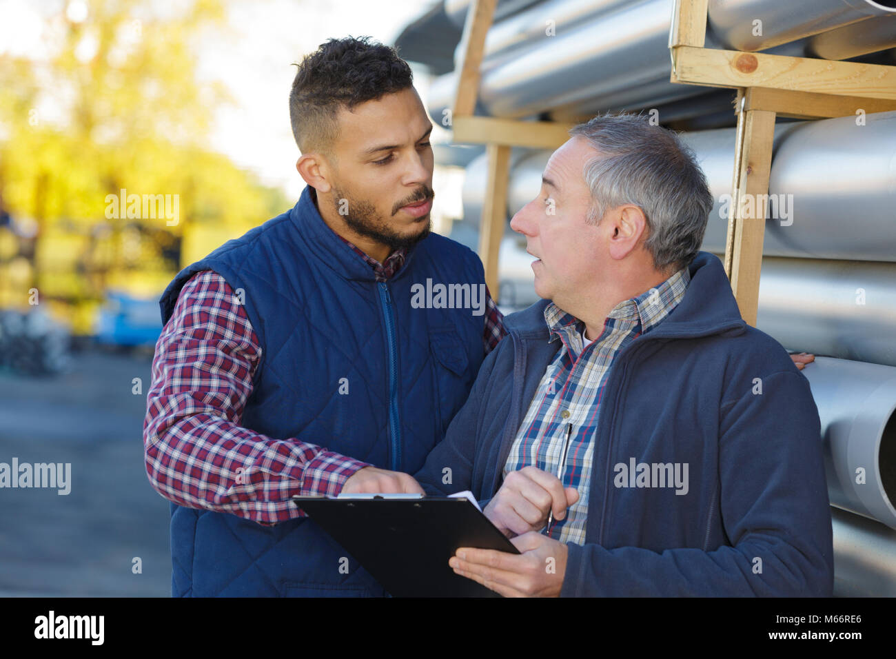 two mechanical engineers working on fuel pipeline in plant Stock Photo ...