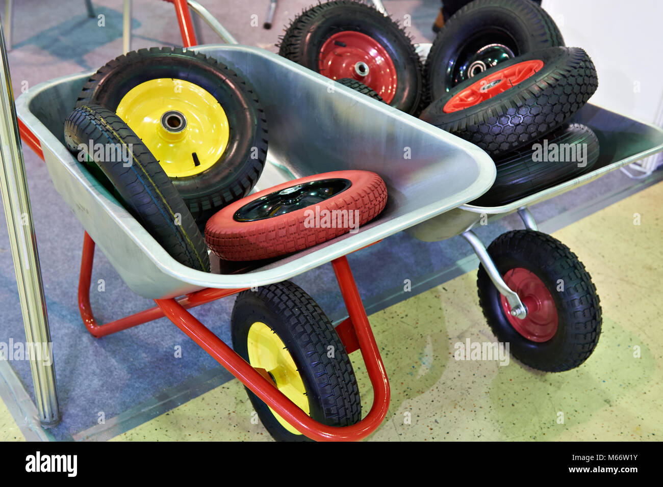 Garden wheelbarrows with spare wheels in the shop Stock Photo