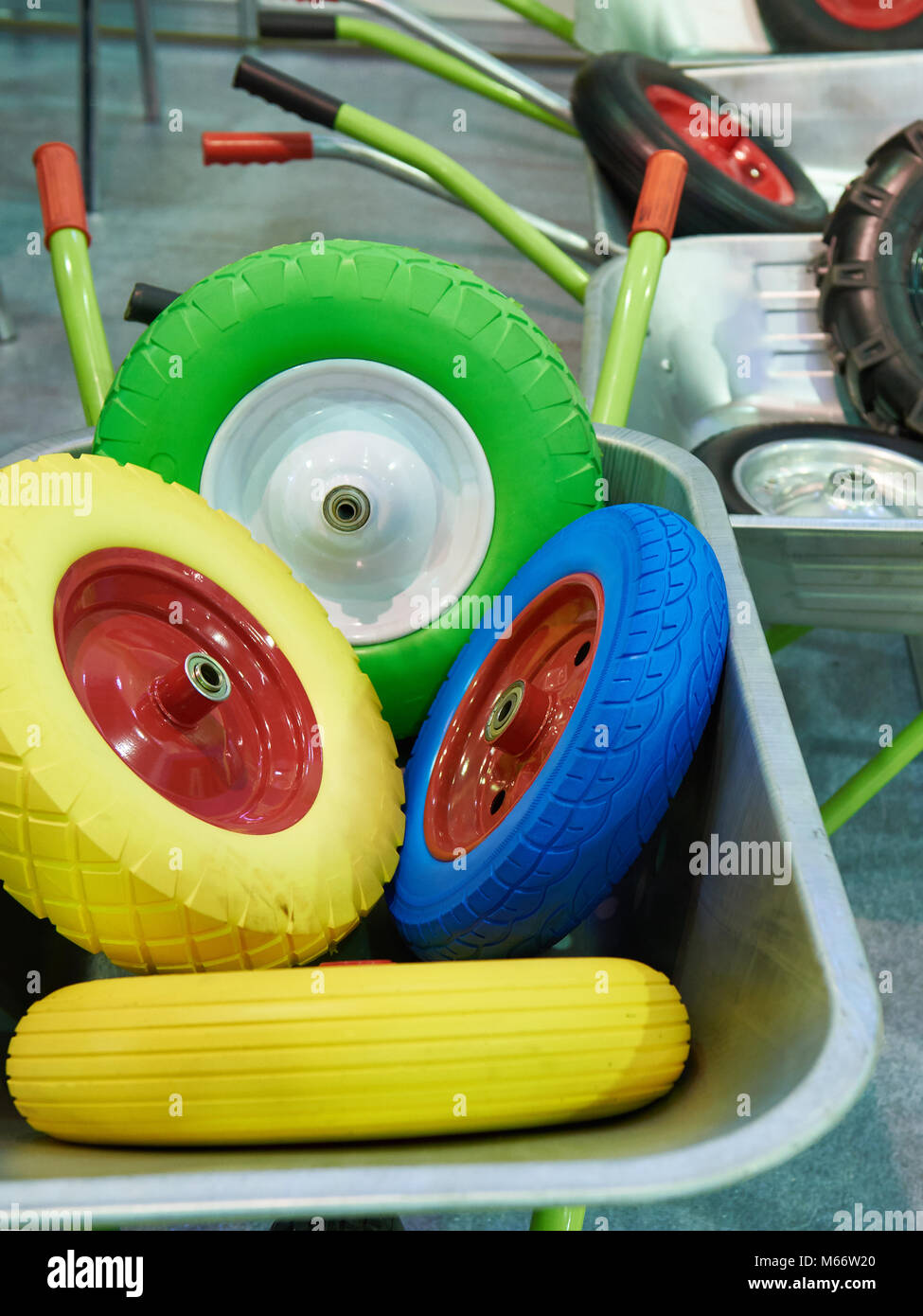 Spare wheels of garden wheelbarrows in the shop Stock Photo