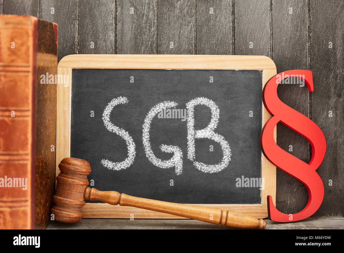 German abbreviation SGB for Sozialgesetzbuch (Sozial Book of law) on chalkboard and paragraph as law concept Stock Photo