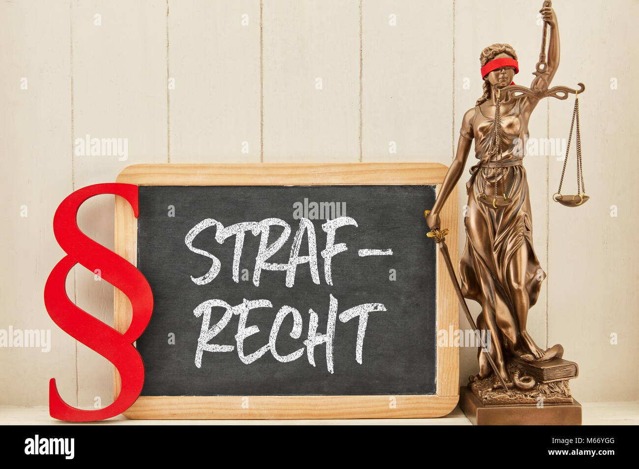 German word Strafrecht (criminal law) with Justitia on blackboard next to a paragraph Stock Photo
