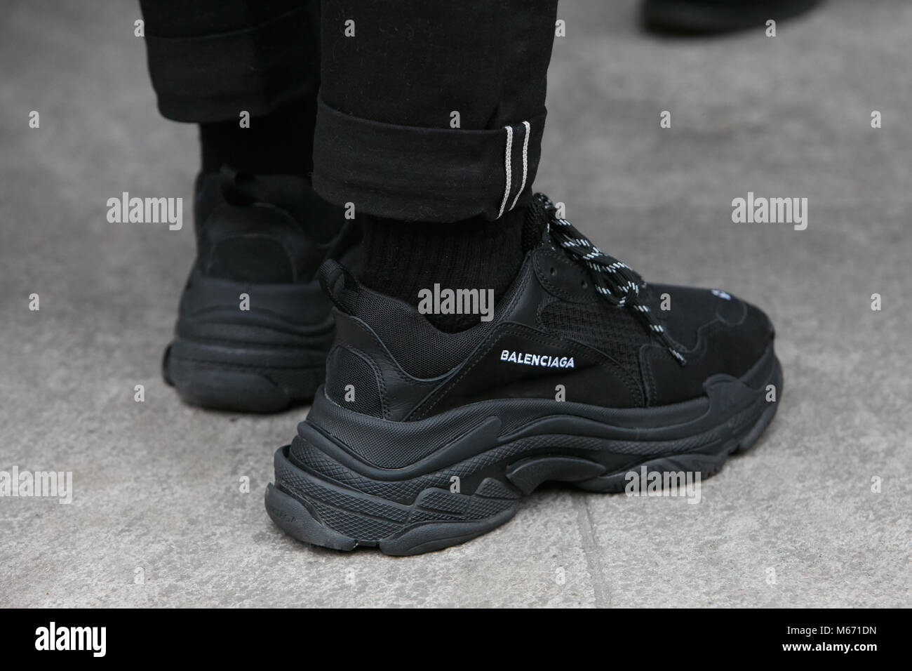 MILAN - FEBRUARY 25: Man with black Balenciaga sneakers before Emporio  Armani fashion show, Milan Fashion Week street style on February 25, 2018  in Mi Stock Photo - Alamy
