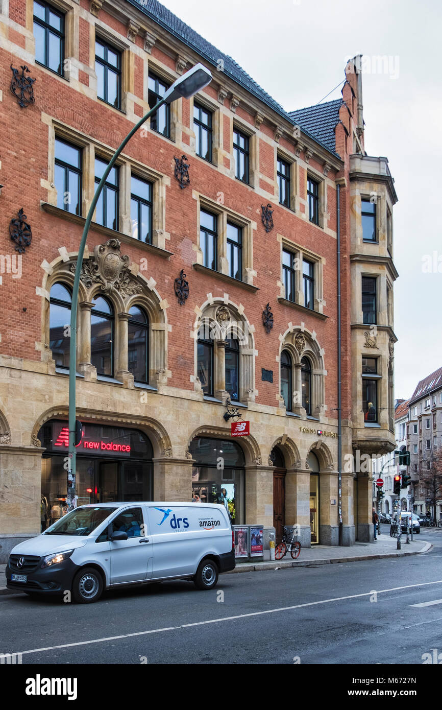 Berlin, Mitte, New Balance Shop & Tommy Hilfiger designer clothing store in  old listed brick and stone building Stock Photo - Alamy