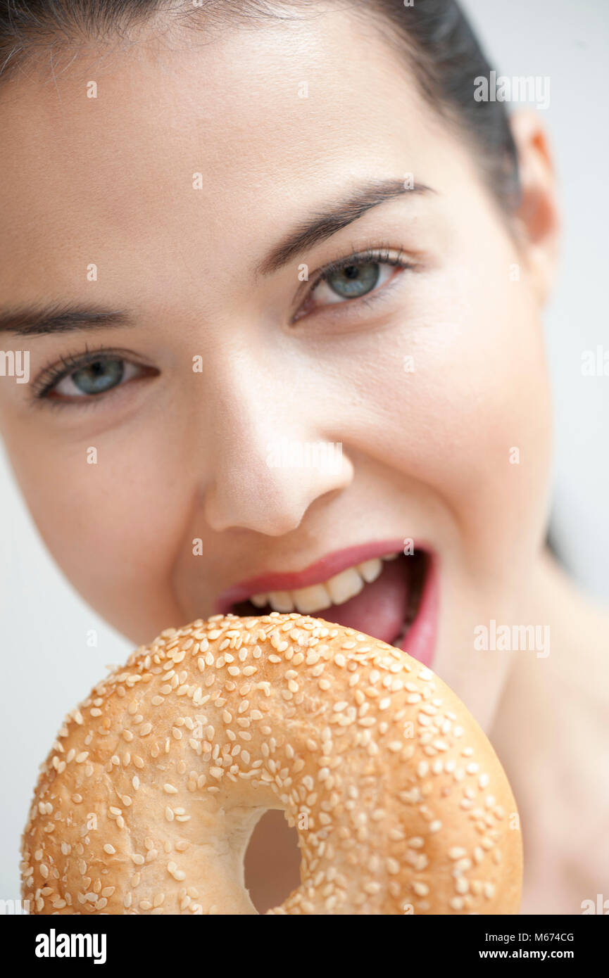 Woman with sesame seed bagel Stock Photo Alamy