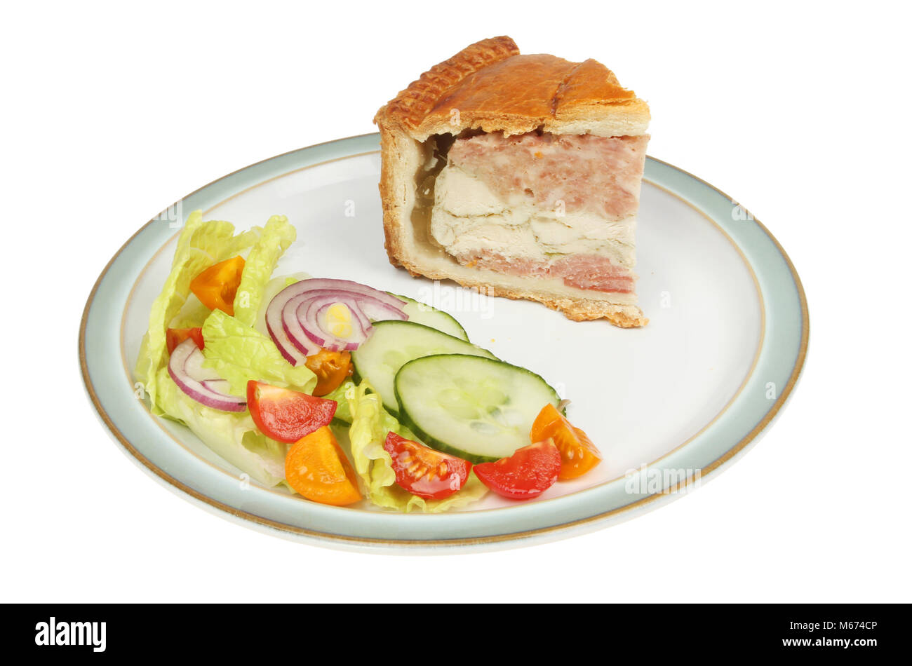 Layered chicken, pork and ham pie with salad on a plate isolated