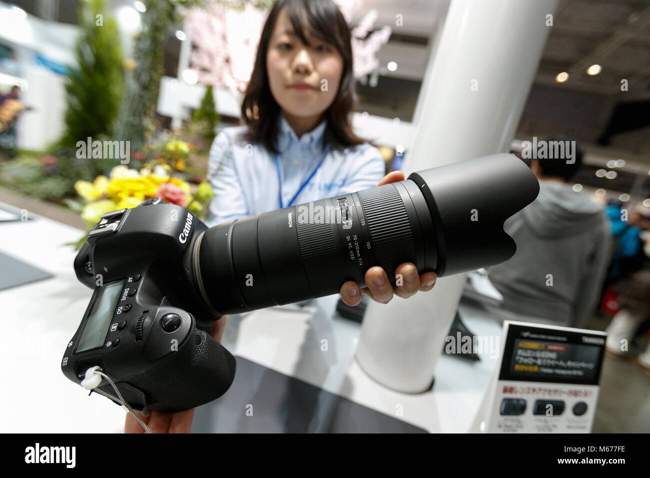 Yokohama, Japan. 1st Mar, 2018. An exhibitor shows the new long lens Tamron 70-210mm F/4 Di VC USD (Model A034) at the CP  Camera & Photo Imaging Show 2018 on March 1, 2018, Yokohama, Japan. CP  is Japan's largest camera and photo imaging exhibition. This year, 1,123 exhibitor booths and approximately 70,000 visitors are expected during the four-day trade show which is held at the Pacifico Yokohama and OSANBASHI Hall until March 4th. Credit: Rodrigo Reyes Marin/AFLO/Alamy Live News Stock Photo