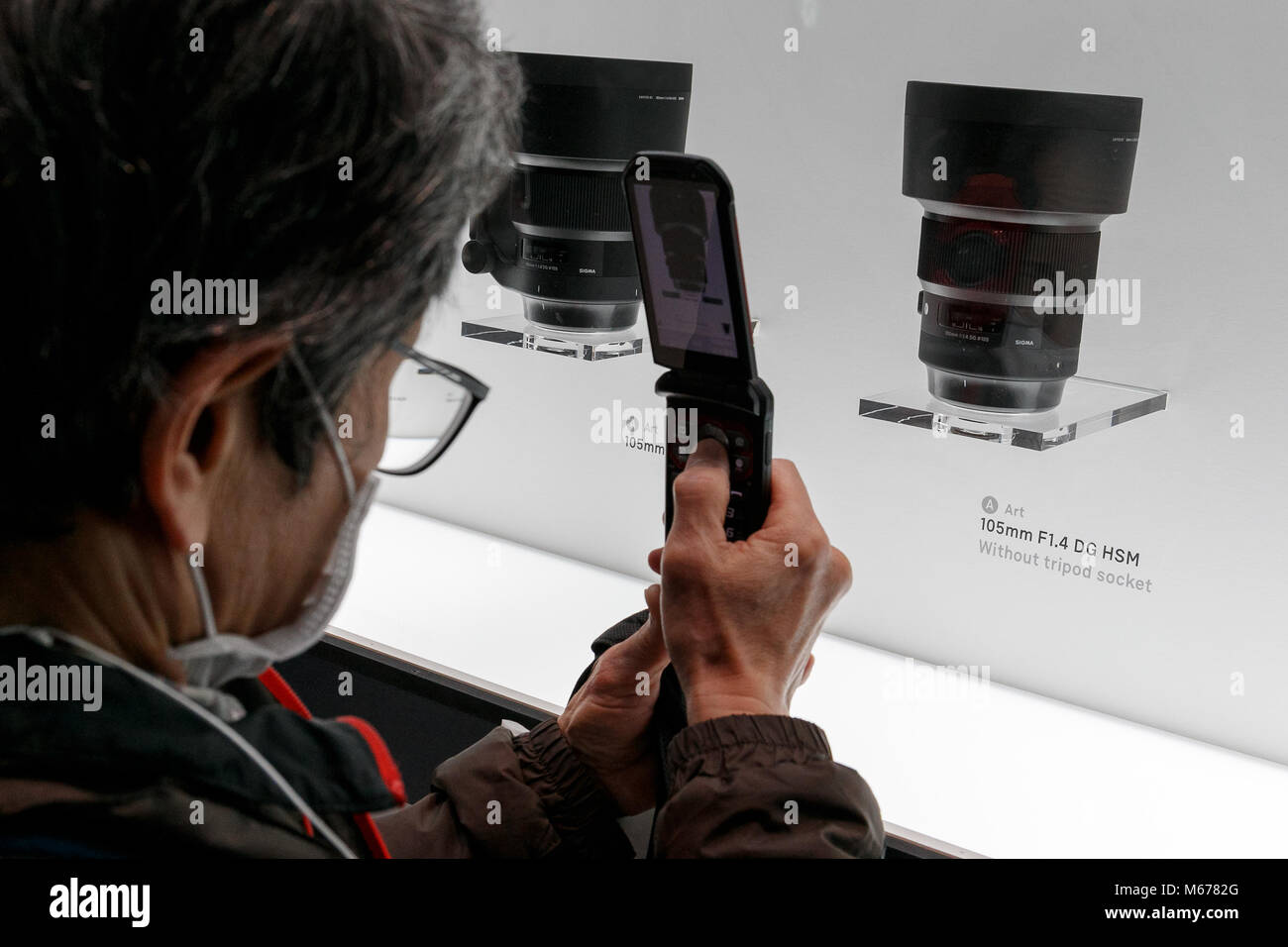 Yokohama, Japan. 1st Mar, 2018. A man takes a picture of the new Sigma lens 105mm F1.4 DG HSM Art on display at the CP  Camera & Photo Imaging Show 2018 on March 1, 2018, Yokohama, Japan. CP  is Japan's largest camera and photo imaging exhibition. This year, 1,123 exhibitor booths and approximately 70,000 visitors are expected during the four-day trade show which is held at the Pacifico Yokohama and OSANBASHI Hall until March 4th. Credit: Rodrigo Reyes Marin/AFLO/Alamy Live News Stock Photo