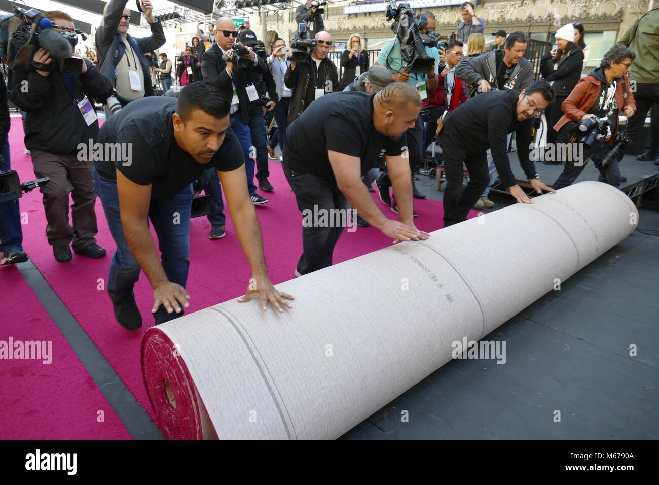Los Angeles, USA. 26th Feb, 2018. Workers rolling out the red carpet in front of the Dolby theatre in Los Angeles, US, 26 February 2018. The Oscar Awards take place there on 04 March 2018. Credit: Barbara Munker/dpa/Alamy Live News Stock Photo