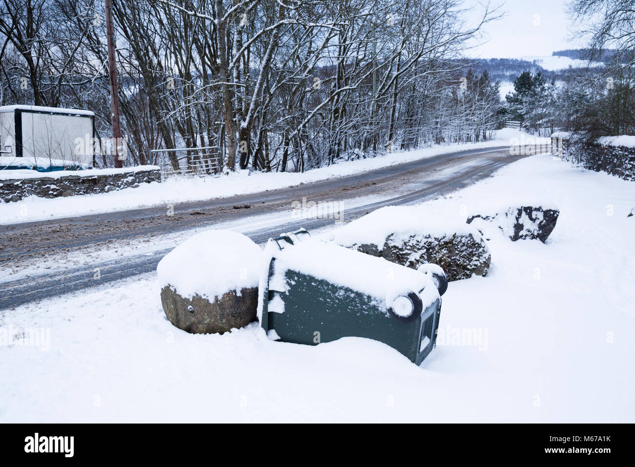 Aberfeldy, Scotland. 1st March 2018. British weather - wheelie bin fallen in the snow after blizzard conditions. Credit: Adam Seward/Alamy Live News Stock Photo