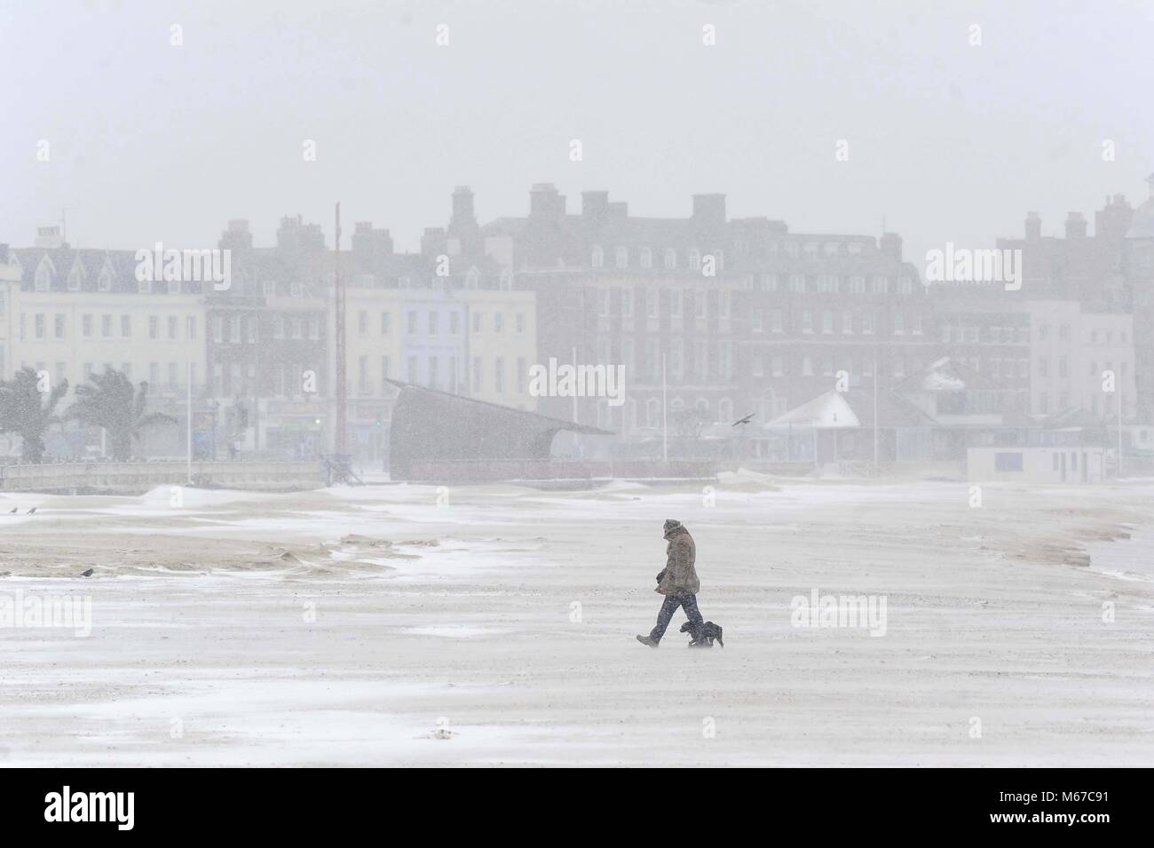 Snow on Weymouth Beach, Dorset, UK Credit: Finnbarr Webster/Alamy Live News Stock Photo