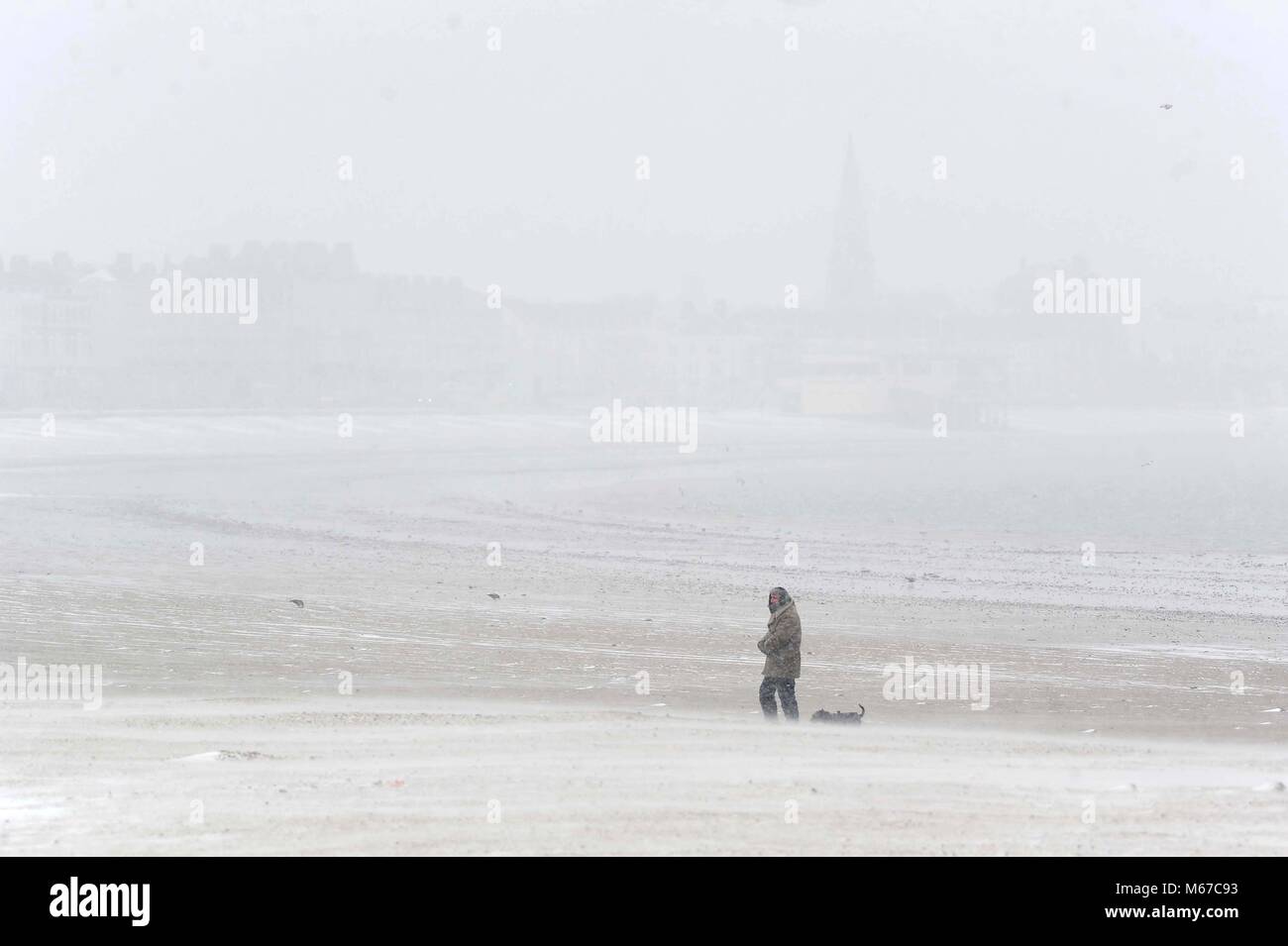 Snow on Weymouth Beach, Dorset, UK Credit: Finnbarr Webster/Alamy Live News Stock Photo