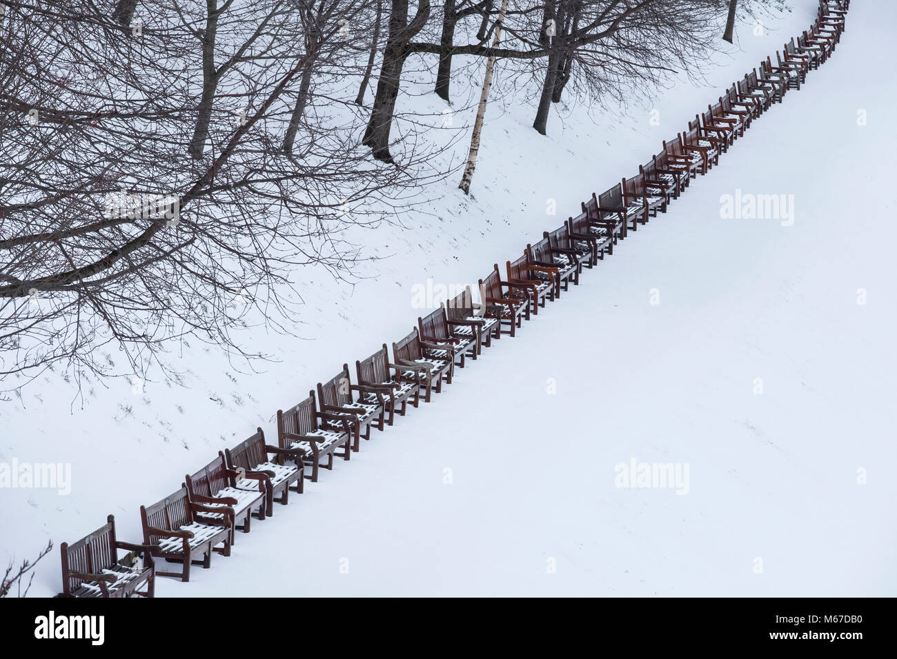 Edinburgh, Scotland, United Kingdom, 1 March, 2018. Heavy snowfalls continue across the city from the storm known as The Beast from the East. Most shops are closed and transport services have been cancelled. Pictured; Princes Street Gardens closed to the public leaving snow pristine. A row of park benches lie empty. Credit: Iain Masterton/Alamy Live News Stock Photo