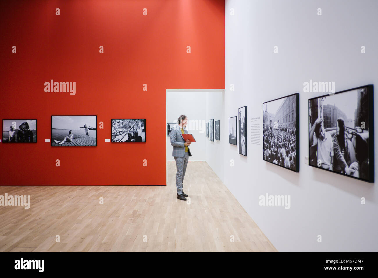 01 March 2018, Germany, Wolfsburg:A visitor standing in the exhibition 'Robert Lebeck 1968'. The art museum is showing a collection of previously unreleased photographs of Lebeck, dealing with the year of upheaval of 1968 in various countries. The exhibition will be running from 04 March to 22 July 2018. Photo: Ole Spata/dpa Stock Photo