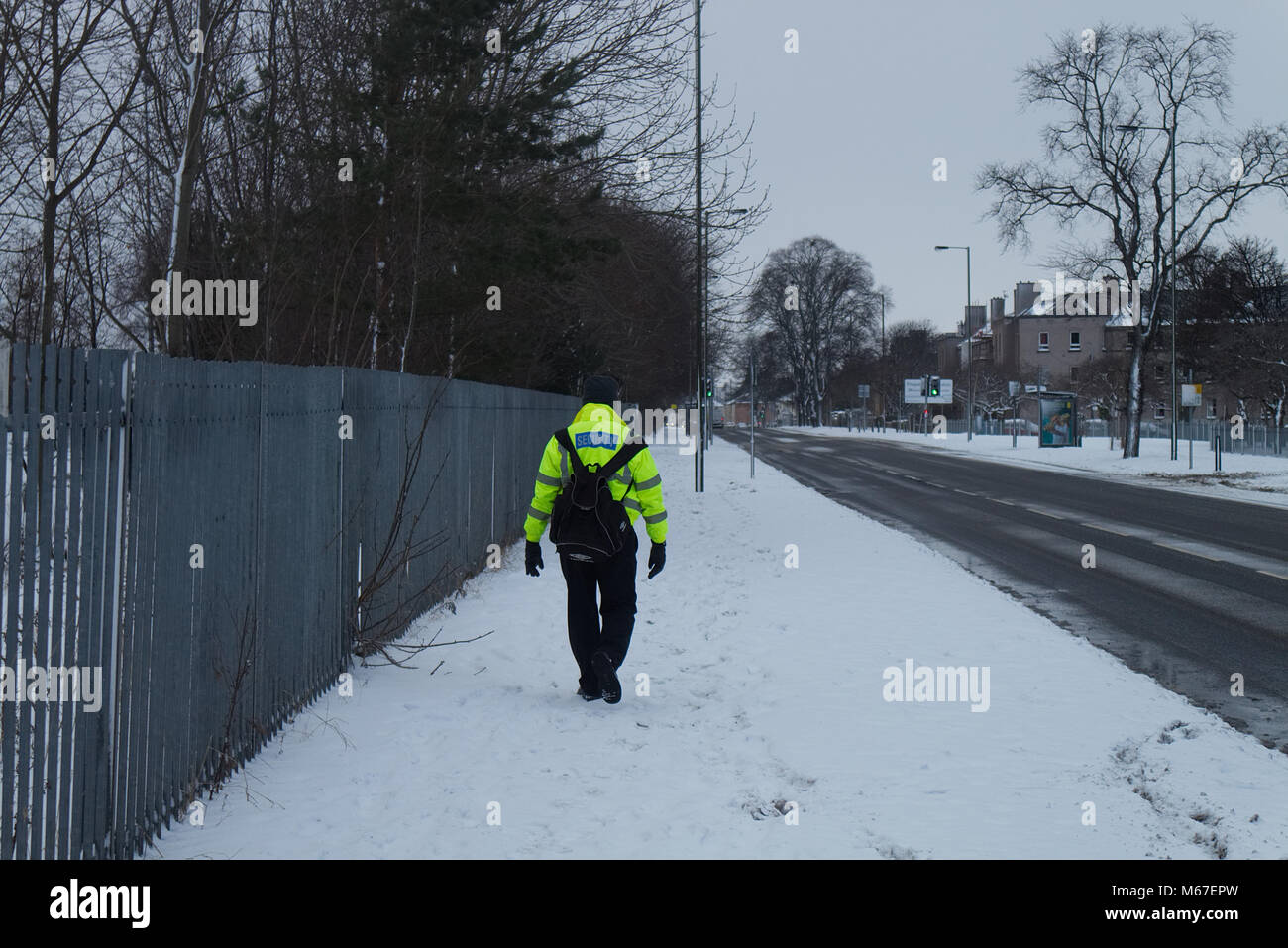 Edinburgh, Scotland, UK. 1st March, 2018. A security guard is walking home from work along a deserted road as there is no public transport running during the Beast of the East storm hitting Edinburgh, Scotland. Credit: Iscotlanda/Alamy Live News Stock Photo