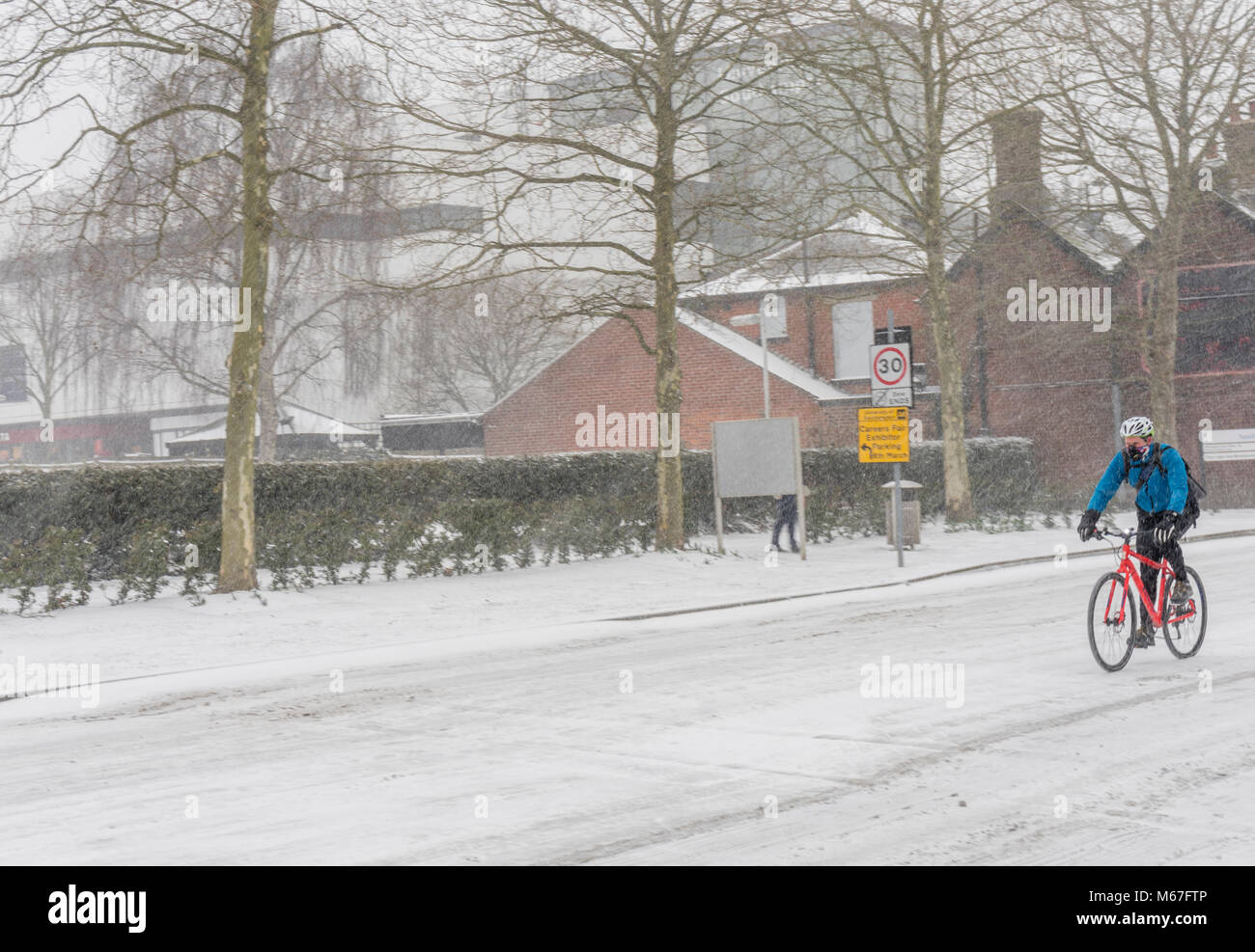 Southampton, UK. 1st of March 2018. Heavy snow has caused the University of Southampton (England, UK) to shut down for business for the rest of the day as well as tomorrow due to adverse and hazardous weather conditions. Pictured here is a cyclist braving the roads which are dangerous to use. Stock Photo