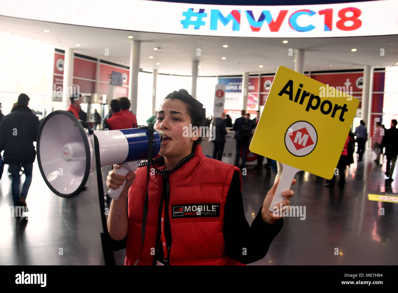 Barcelona, Spain. 1st Mar, 2018. A worker of the GSMA guide visitors to the airport exit at the Mobile World Congress in Barcelona.The Mobile World Congress 2018 is being hosted in Barcelona from 26 February to 1st March. Credit: Workers that make possible the MWC7  3 .jpg/SOPA Images/ZUMA Wire/Alamy Live News Stock Photo