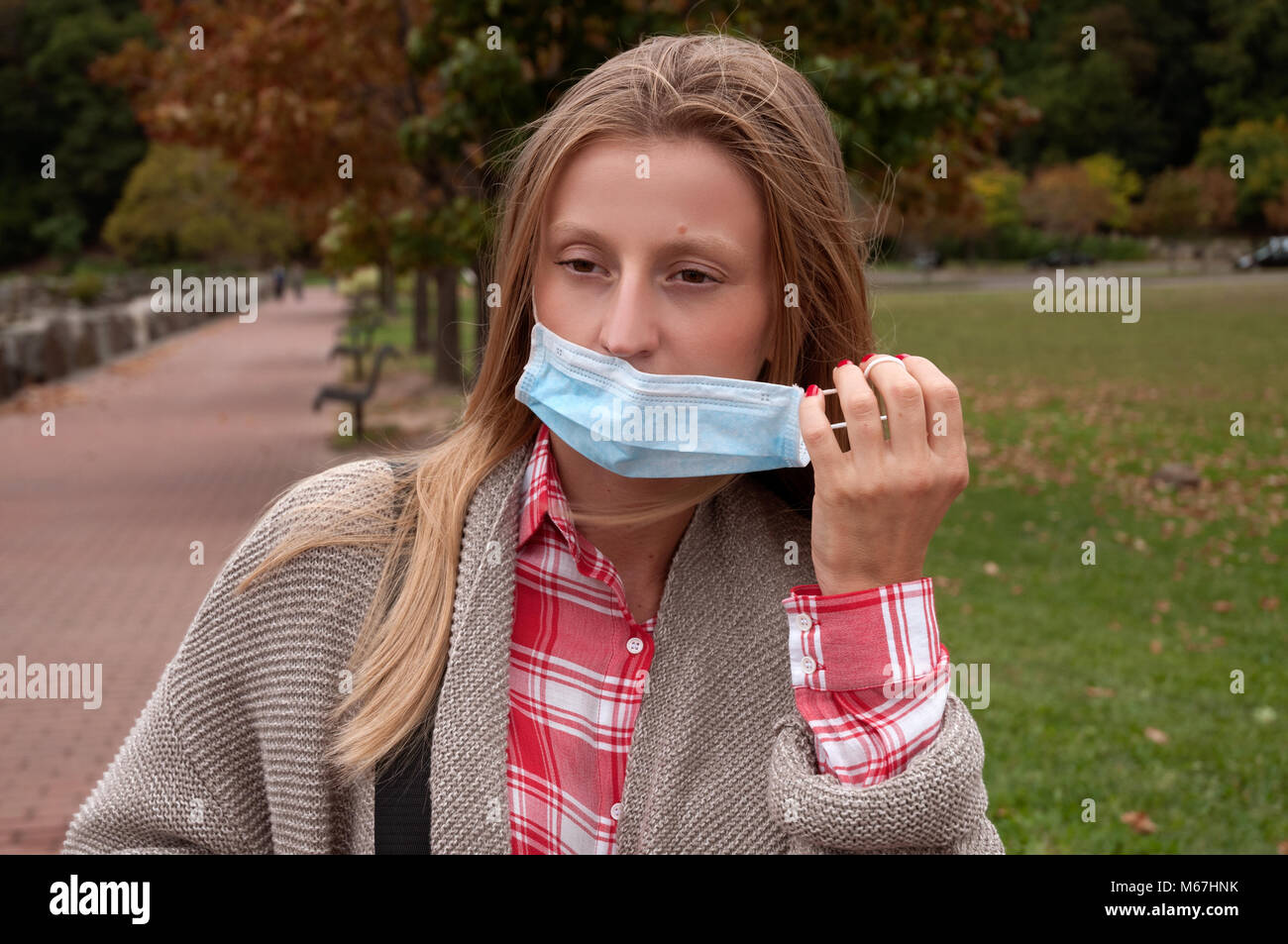 Woman has cold or flu. Girl has catch cold in the park Stock Photo Alamy