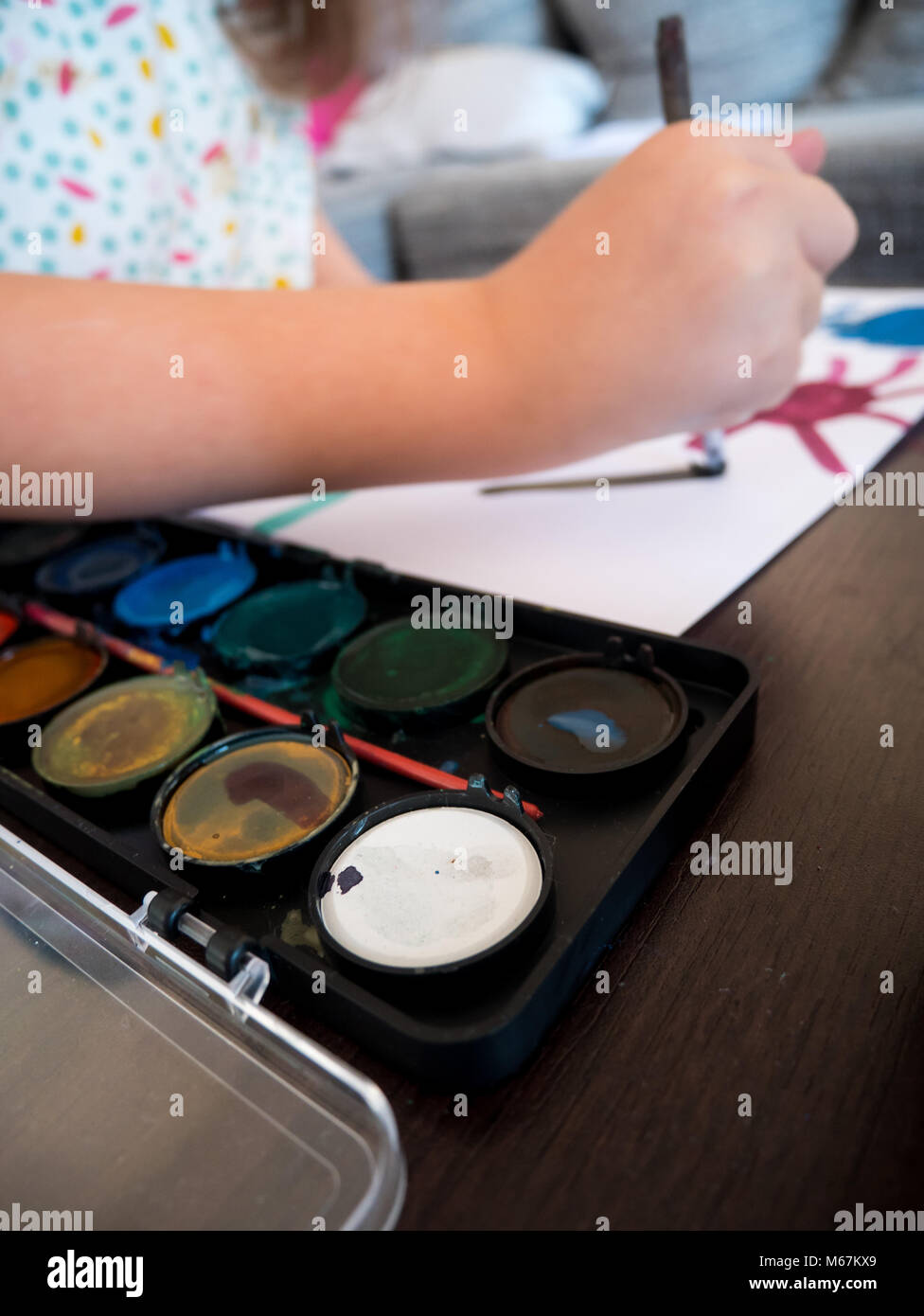 Small girl painting with watercolors at home Stock Photo - Alamy