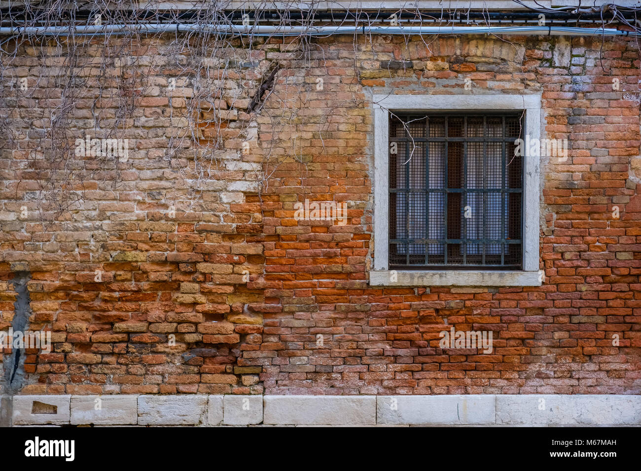 Old window with red exposed bricks in Venice Stock Photo Alamy