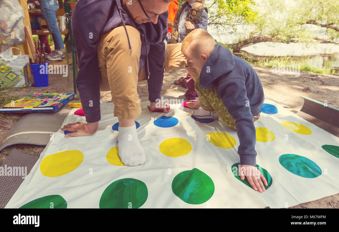 Kids playing twister game outdoors Stock Photo - Alamy